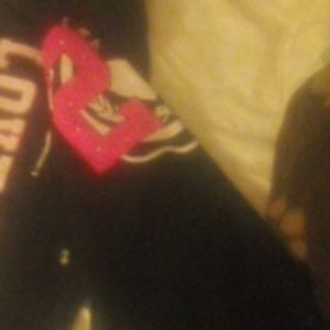 Black joggers with white and pink lettering